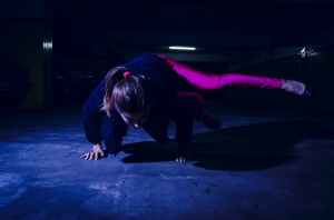 woman wearing purple leggings dancing hip hop