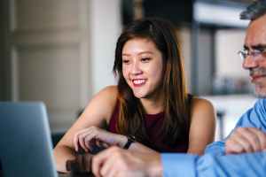 woman and man looking at laptop
