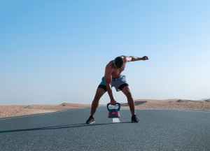 man holding kettlebell on road