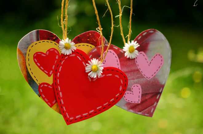three red hearts hanging with white flowers